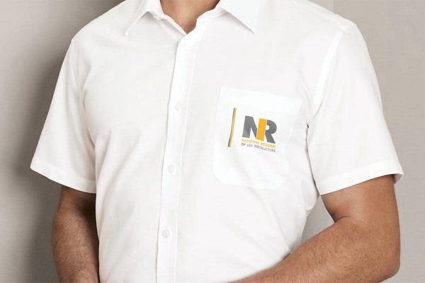 Person wearing NRI branded Short Sleeve Shirt